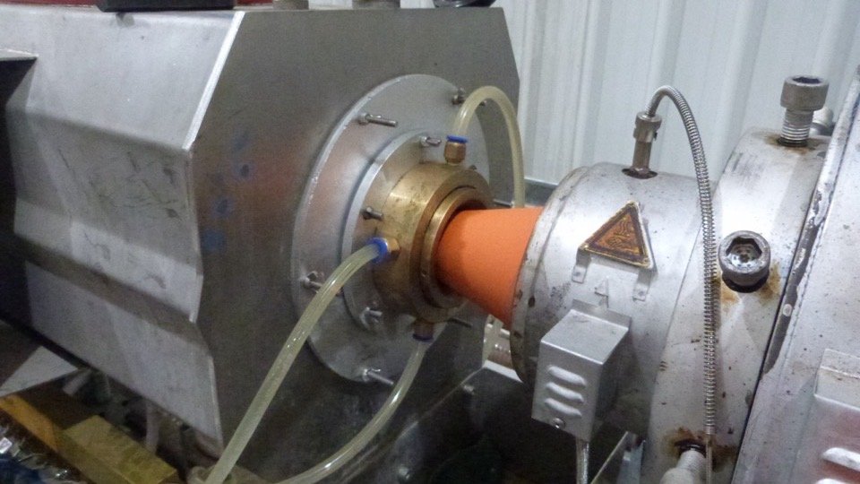 HDPE pipe emerging from an extrusion line