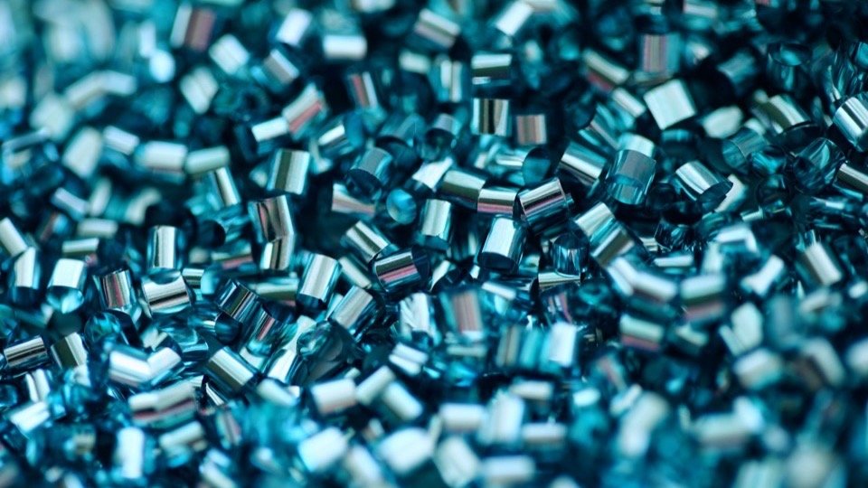 Close-up of teal recycled HDPE granules